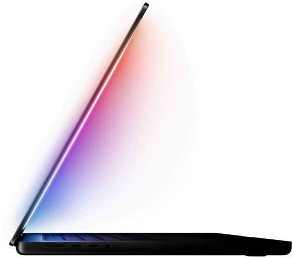 A slightly open MacBook Pro casts a multicoloured glow from the screen onto the keyboard