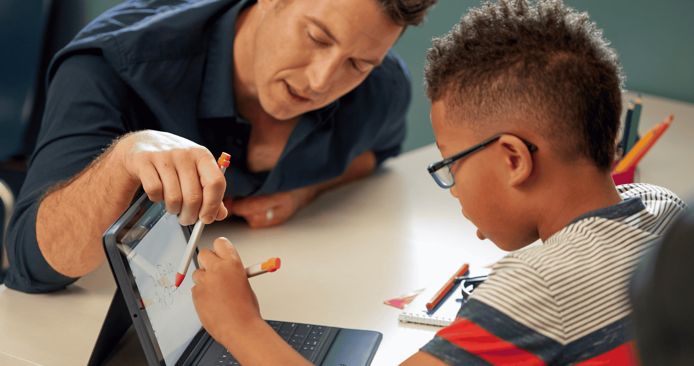 Logitech case with keyboard on iPad - teacher helping a student using logitech stylus'