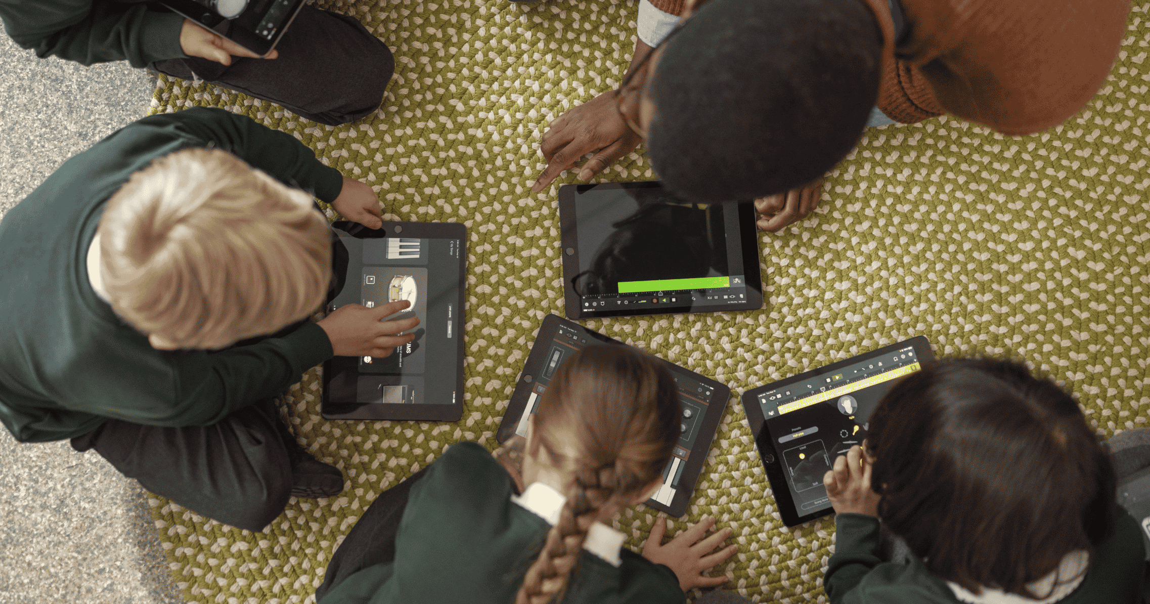 Students use iPads for a music lesson