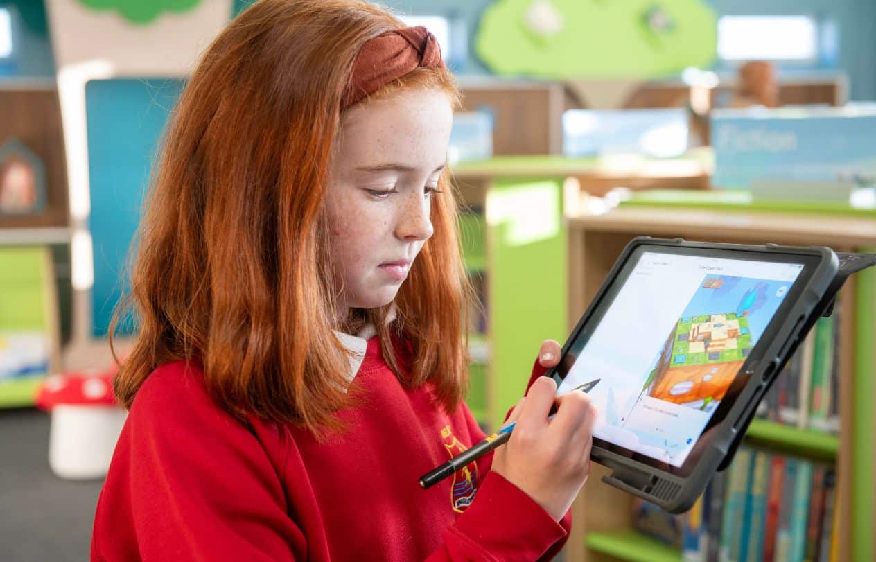 Young female pupil using iPad and Swift Playgrounds to learn how to code.