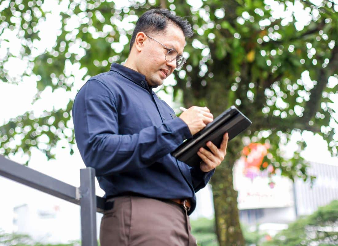 Professional staff member updating records in the field using their iPad.