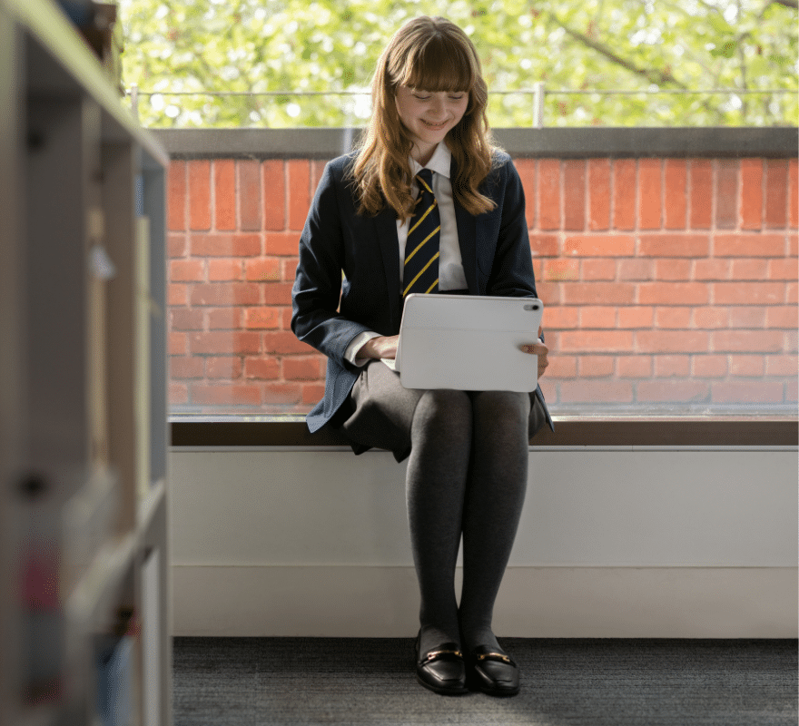 Student sat using iPad