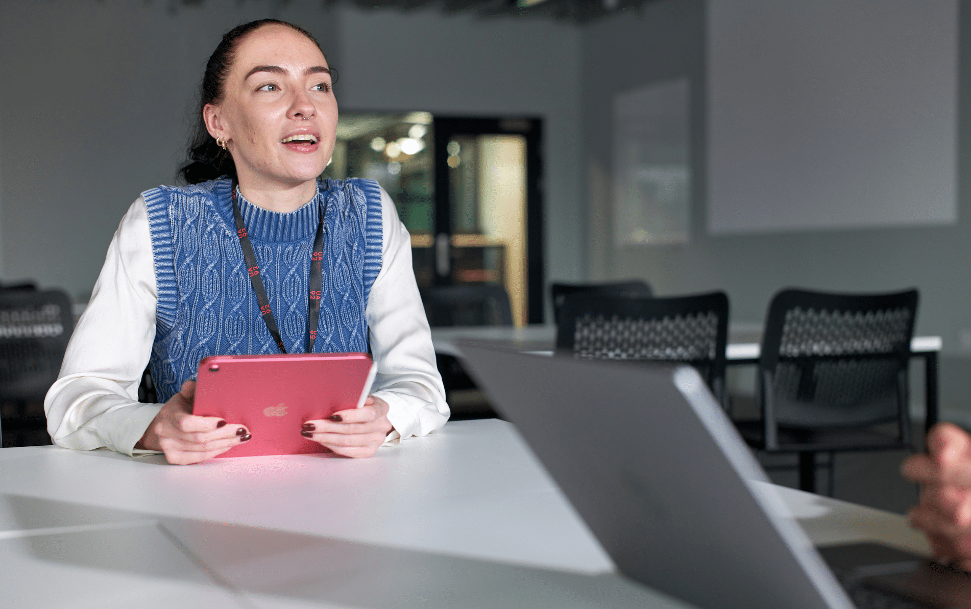 Worker holding iPad in meeting room