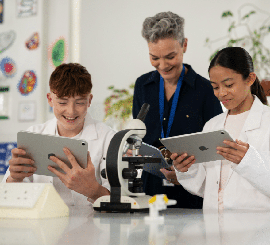 Teacher overseeing students use iPad in Science